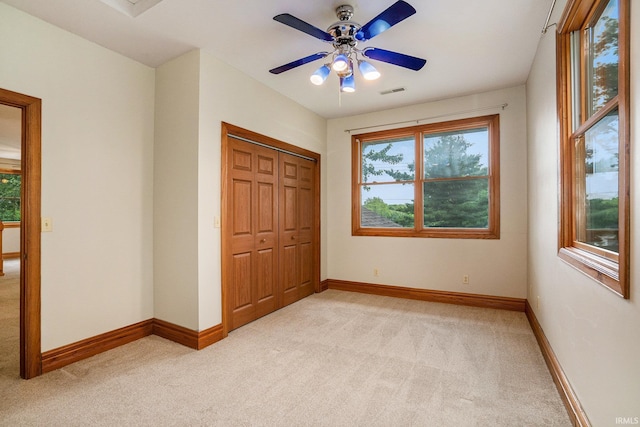 10227 Jefferson Rd, Osceola, IN 46561 - unfurnished bedroom with light carpet, multiple windows, a closet, and baseboards