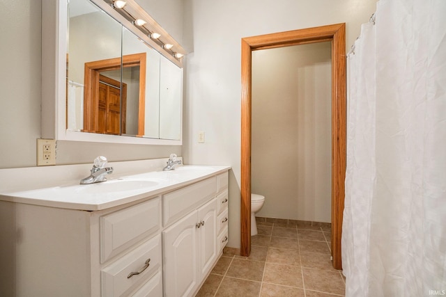 10227 Jefferson Rd, Osceola, IN 46561 - bathroom featuring double vanity, toilet, and tile patterned flooring