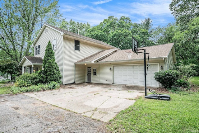 10227 Jefferson Rd, Osceola, IN 46561 - view of front of house with an attached garage, driveway, a shingled roof, and a front lawn
