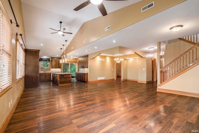 10227 Jefferson Rd, Osceola, IN 46561 - unfurnished living room with a ceiling fan, a chandelier, dark wood-style flooring, a sink, and stairway