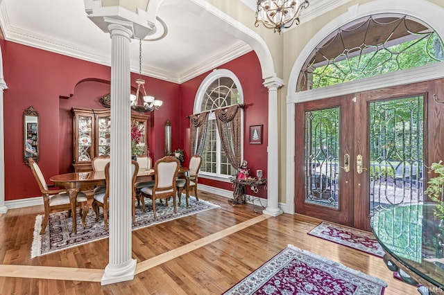1411 Santanna Dr, Lafayette, IN 47905 - foyer featuring a chandelier, ornate columns, crown molding, and wood-type flooring
