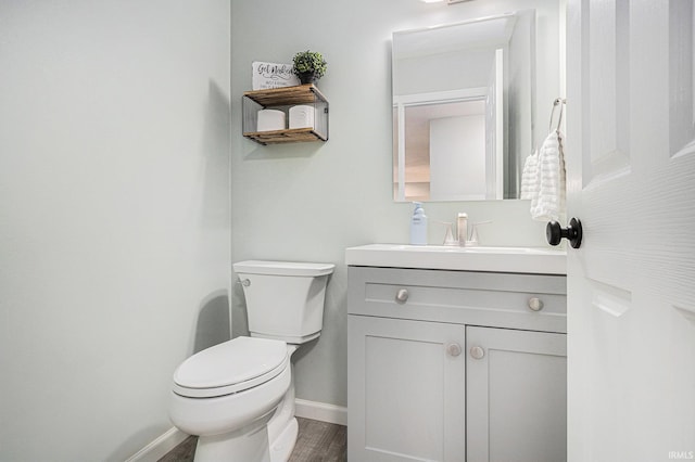 55177 Ardith St, Osceola, IN 46561 - half bath featuring baseboards, toilet, vanity, and wood finished floors
