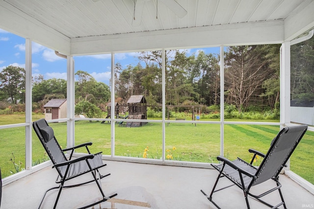 55177 Ardith St, Osceola, IN 46561 - unfurnished sunroom with healthy amount of natural light, view of wooded area, and a ceiling fan