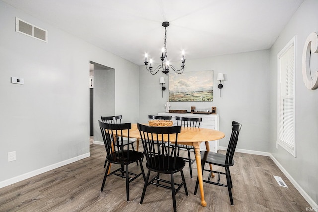 55177 Ardith St, Osceola, IN 46561 - dining space featuring wood finished floors, a chandelier, and baseboards