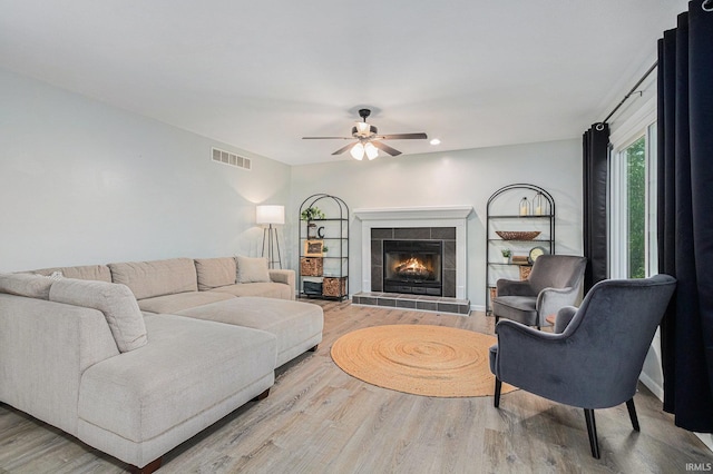 55177 Ardith St, Osceola, IN 46561 - living room with a ceiling fan, wood finished floors, and a tiled fireplace