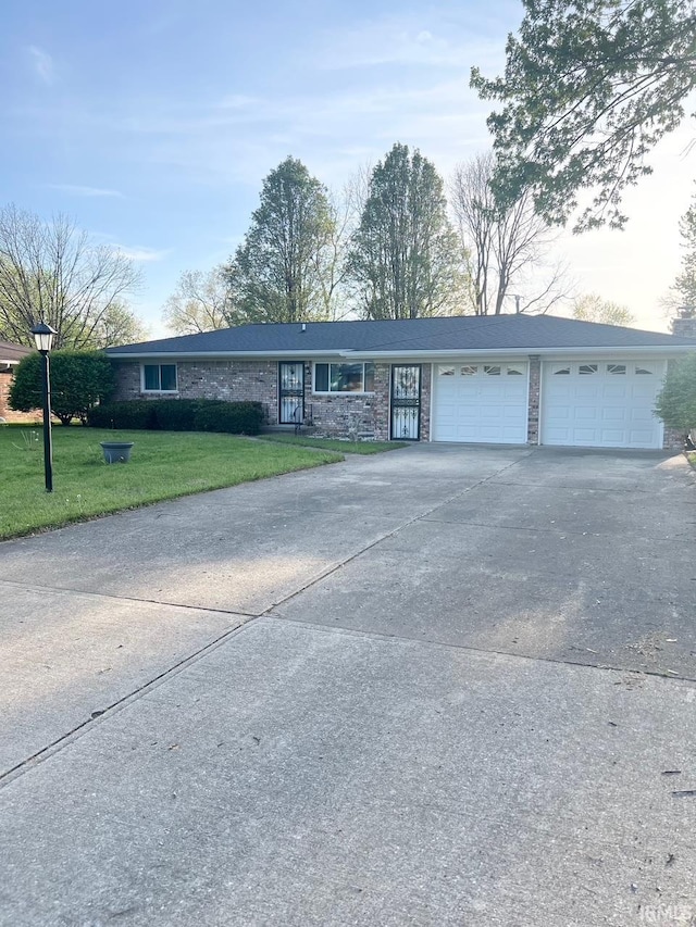 416 Hopkins Rd, Indianapolis, IN 46229 - ranch-style house featuring concrete driveway, a front yard, and an attached garage