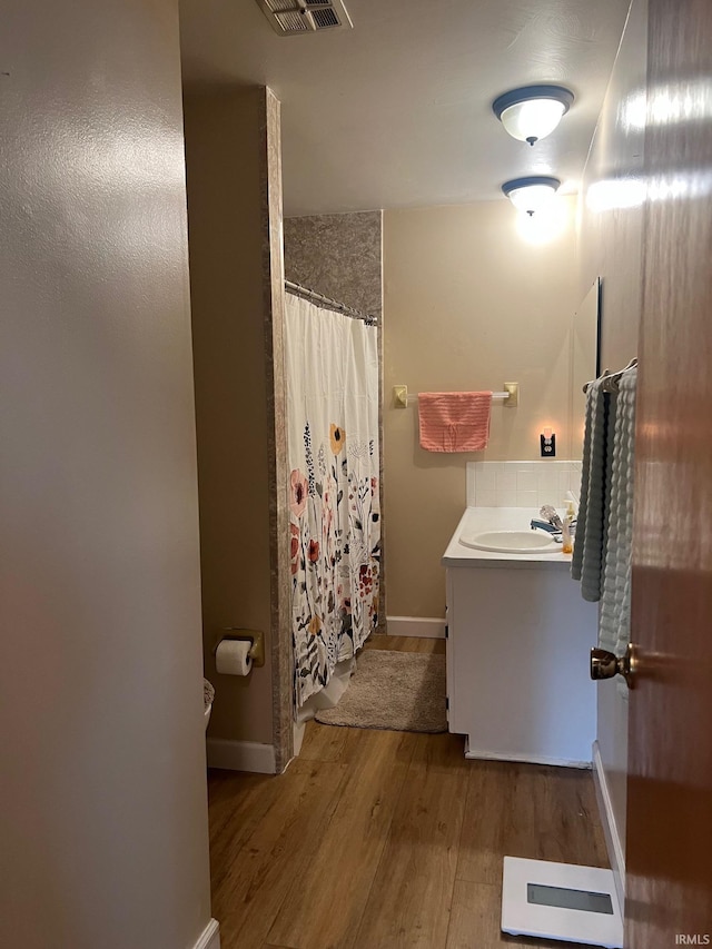 416 Hopkins Rd, Indianapolis, IN 46229 - full bathroom featuring vanity, wood finished floors, a shower with curtain, and baseboards