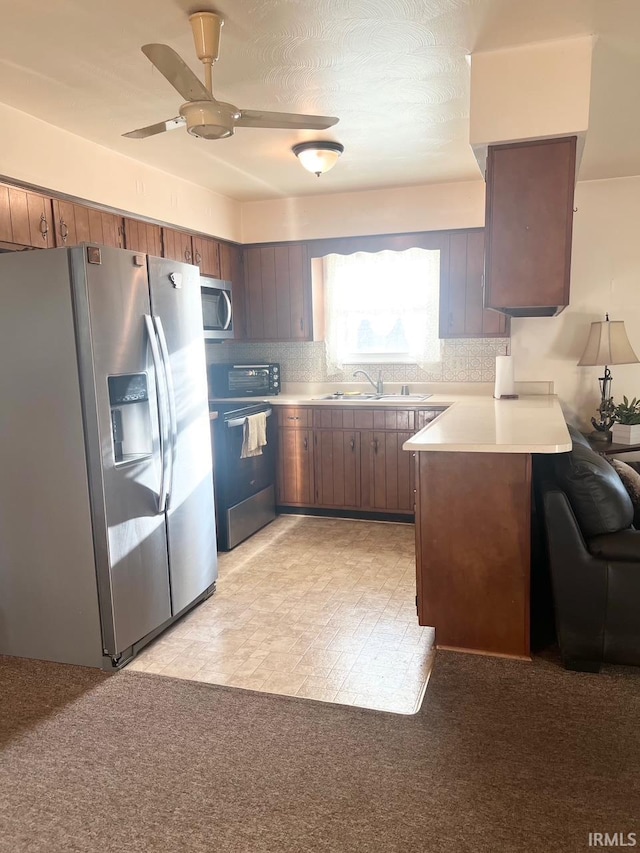 416 Hopkins Rd, Indianapolis, IN 46229 - kitchen with stainless steel appliances, light countertops, ceiling fan, a peninsula, and a sink
