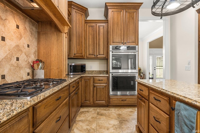 4906 N 100 W, Uniondale, IN 46791 - kitchen with appliances with stainless steel finishes, brown cabinets, tasteful backsplash, and light stone counters