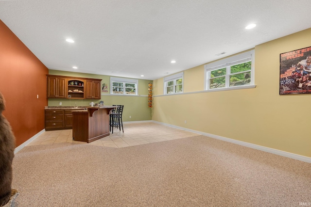 4906 N 100 W, Uniondale, IN 46791 - kitchen with a kitchen bar, open shelves, recessed lighting, baseboards, and light carpet
