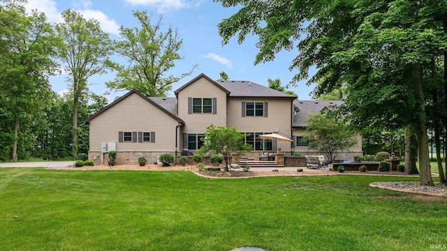 4906 N 100 W, Uniondale, IN 46791 - rear view of house with a lawn and a patio