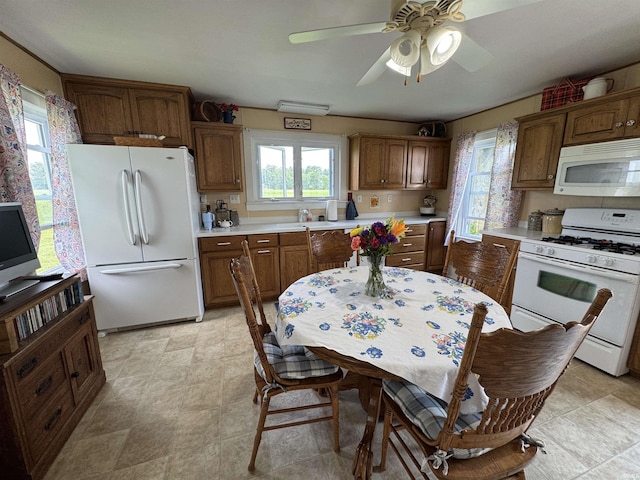 3151 W 150 N, Logansport, IN 46947 - kitchen featuring white appliances, light countertops, ceiling fan, and brown cabinetry