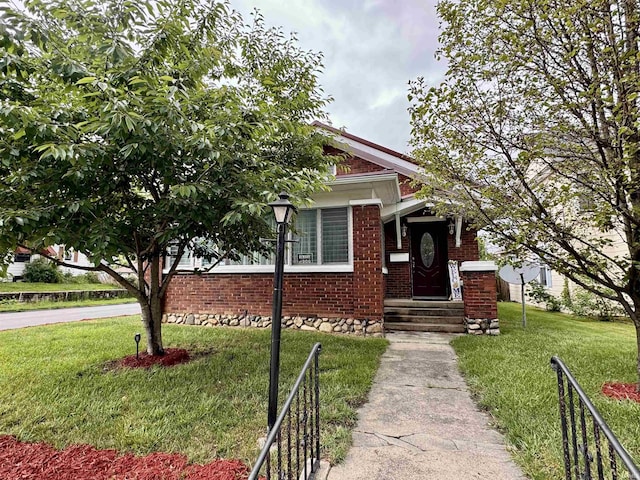 636 W 1st St, Marion, IN 46952 - view of property hidden behind natural elements with a front lawn and brick siding
