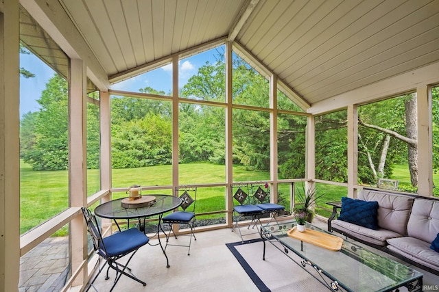 51803 Foxdale Ln, Granger, IN 46530 - sunroom / solarium featuring outdoor lounge area, vaulted ceiling, and view of wooded area