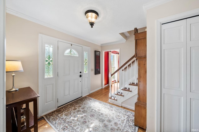 51803 Foxdale Ln, Granger, IN 46530 - entrance foyer featuring ornamental molding, light wood-type flooring, stairway, and baseboards