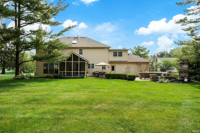 51803 Foxdale Ln, Granger, IN 46530 - rear view of house with a sunroom, a lawn, a shingled roof, and a patio area