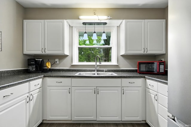 9014 Muldoon Rd, Fort Wayne, IN 46819 - kitchen with a sink, white cabinets, and dark countertops