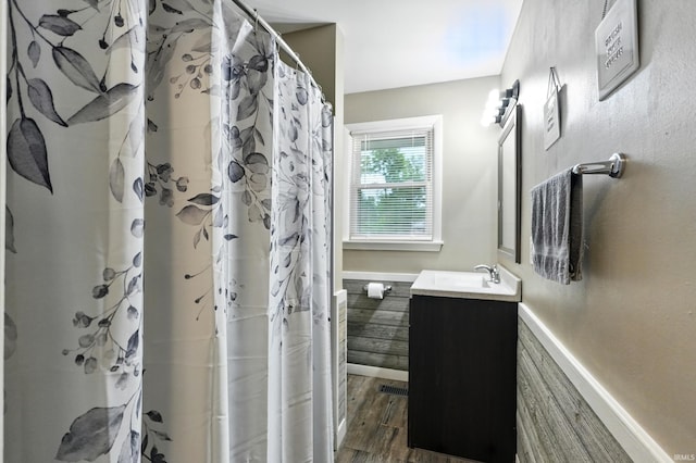 9014 Muldoon Rd, Fort Wayne, IN 46819 - full bathroom featuring vanity, wood finished floors, and a shower with curtain