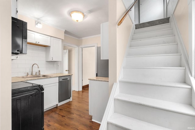 1218 S Twyckenham Dr, South Bend, IN 46615 - kitchen featuring a sink, stainless steel dishwasher, white cabinetry, stove, and decorative backsplash