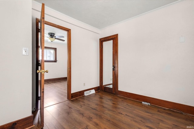 1218 S Twyckenham Dr, South Bend, IN 46615 - empty room featuring crown molding, baseboards, dark wood finished floors, and a ceiling fan