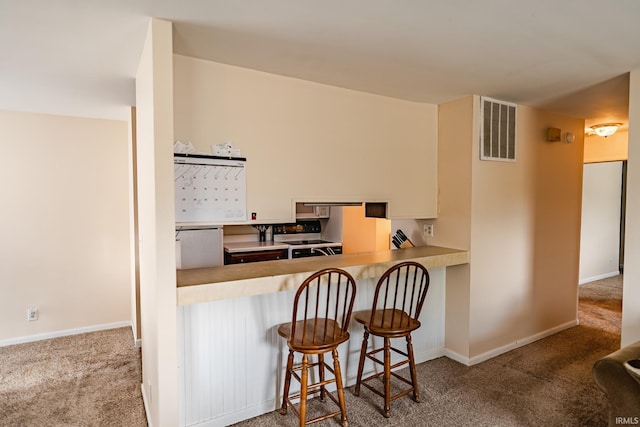 3208 Hanover Dr Unit 17-D, Lafayette, IN 47909 - kitchen with range with electric cooktop, carpet flooring, a breakfast bar, and baseboards