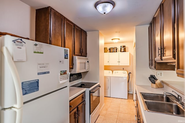 3208 Hanover Dr Unit 17-D, Lafayette, IN 47909 - kitchen featuring white appliances, separate washer and dryer, a sink, light countertops, and light tile patterned floors