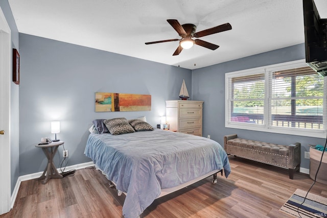 9617 S Lake Ridge Dr Unit 4, Bloomington, IN 47401 - bedroom featuring wood finished floors, baseboards, and ceiling fan
