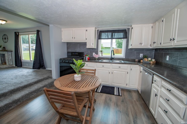 57005 Southshore Dr, Osceola, IN 46561 - kitchen with a sink, black gas range, stainless steel dishwasher, dark countertops, and a textured ceiling