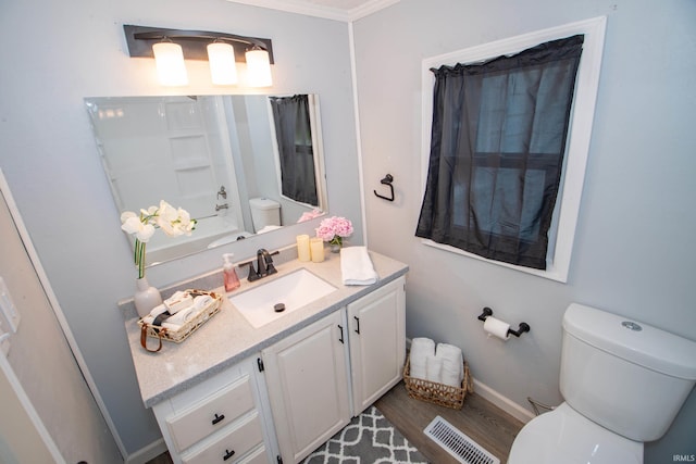 57005 Southshore Dr, Osceola, IN 46561 - bathroom with toilet, vanity, wood finished floors, ornamental molding, and baseboards