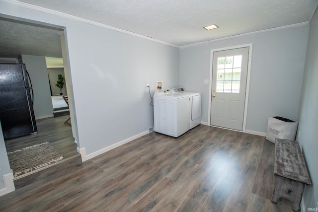 57005 Southshore Dr, Osceola, IN 46561 - washroom featuring washing machine and clothes dryer, ornamental molding, a textured ceiling, dark wood finished floors, and baseboards