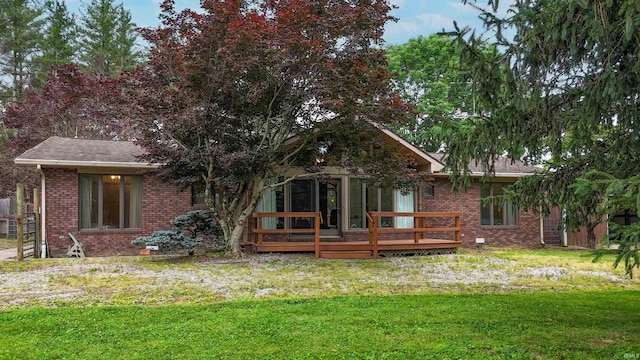 7333 W Newton Stewart Rd, Taswell, IN 47175 - rear view of property with brick siding, a wooden deck, a lawn, and roof with shingles