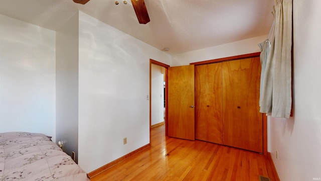 7333 W Newton Stewart Rd, Taswell, IN 47175 - unfurnished bedroom featuring light wood-type flooring, a closet, ceiling fan, and baseboards
