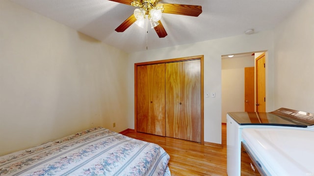 7333 W Newton Stewart Rd, Taswell, IN 47175 - bedroom with separate washer and dryer, light wood finished floors, a closet, ceiling fan, and baseboards