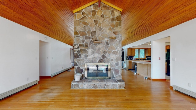 7333 W Newton Stewart Rd, Taswell, IN 47175 - unfurnished living room featuring a baseboard heating unit, wooden ceiling, lofted ceiling, baseboards, and a stone fireplace