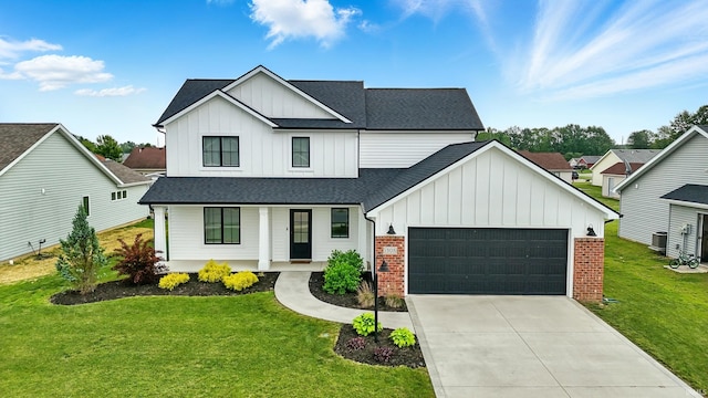 1308 Hideaway Dr, Auburn, IN 46706 - modern farmhouse style home with board and batten siding, a porch, a shingled roof, a front yard, and a garage