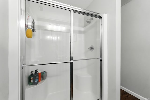 1308 Hideaway Dr, Auburn, IN 46706 - full bathroom with a stall shower, wood finished floors, and baseboards