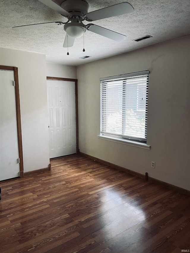 336 Wilmington Ct Unit C, Bloomington, IN 47401 - unfurnished bedroom with wood finished floors, baseboards, a closet, ceiling fan, and a textured ceiling