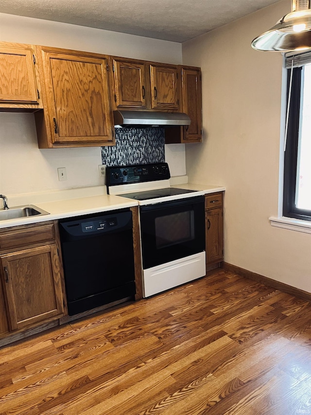 336 Wilmington Ct Unit C, Bloomington, IN 47401 - kitchen with range with electric cooktop, black dishwasher, extractor fan, a sink, and dark wood-type flooring