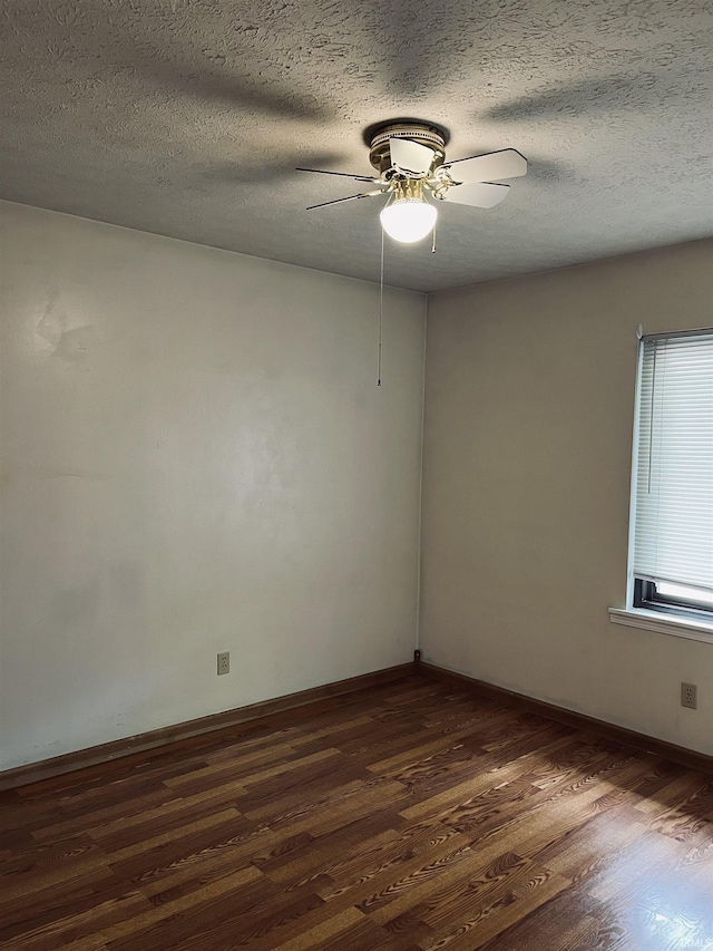 336 Wilmington Ct Unit C, Bloomington, IN 47401 - unfurnished room with dark wood-type flooring, a textured ceiling, ceiling fan, and baseboards