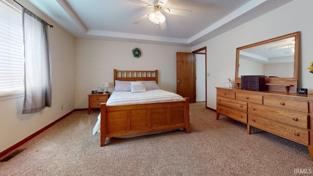 12 Vicki Dr, Vincennes, IN 47591 - bedroom with multiple windows, light colored carpet, a raised ceiling, and a ceiling fan