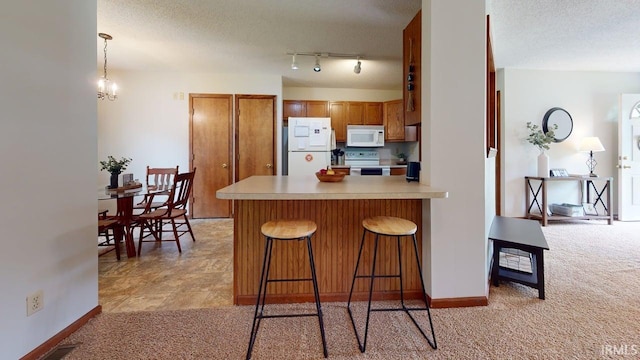 12 Vicki Dr, Vincennes, IN 47591 - kitchen featuring white appliances, brown cabinets, light colored carpet, a peninsula, and a kitchen breakfast bar