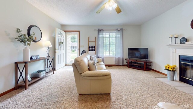 12 Vicki Dr, Vincennes, IN 47591 - carpeted living area with a fireplace with flush hearth, a textured ceiling, ceiling fan, and baseboards