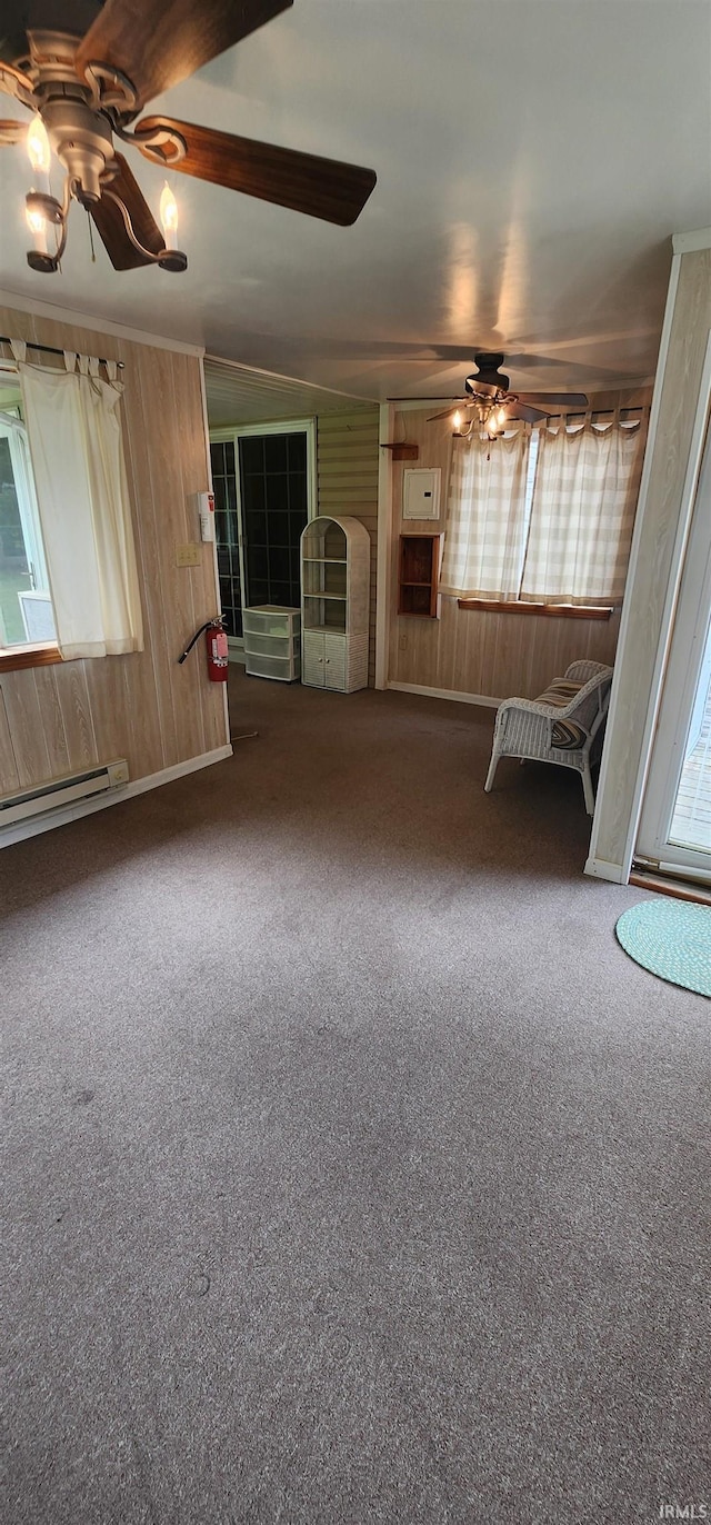12 Vicki Dr, Vincennes, IN 47591 - carpeted empty room with a ceiling fan, a baseboard radiator, and wood walls