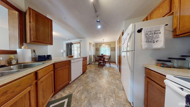 12 Vicki Dr, Vincennes, IN 47591 - kitchen with white appliances, brown cabinets, a textured ceiling, and light countertops
