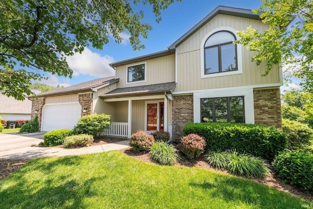 521 Glenmoor Dr, Fort Wayne, IN 46804 - view of front of home with brick siding, a garage, driveway, and a front yard