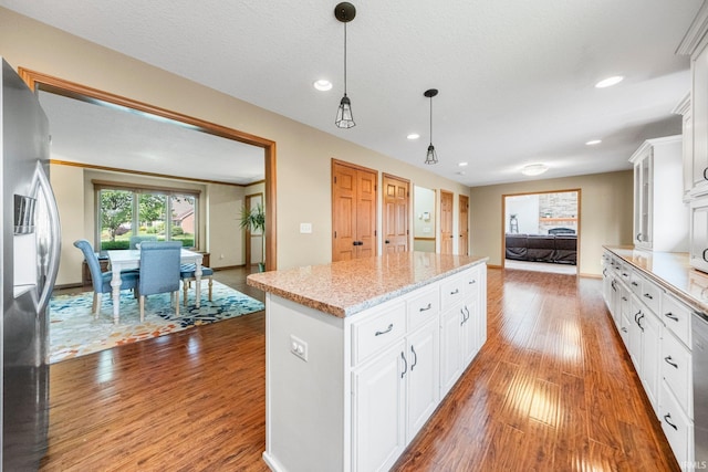 521 Glenmoor Dr, Fort Wayne, IN 46804 - kitchen featuring stainless steel fridge with ice dispenser, a center island, wood finished floors, white cabinets, and recessed lighting