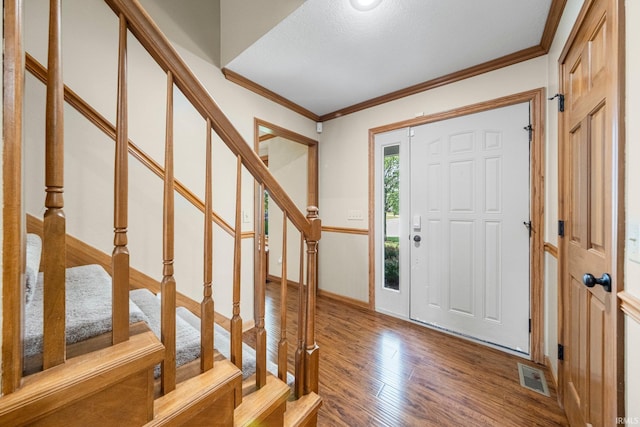 521 Glenmoor Dr, Fort Wayne, IN 46804 - entryway with stairs, wood finished floors, crown molding, and baseboards