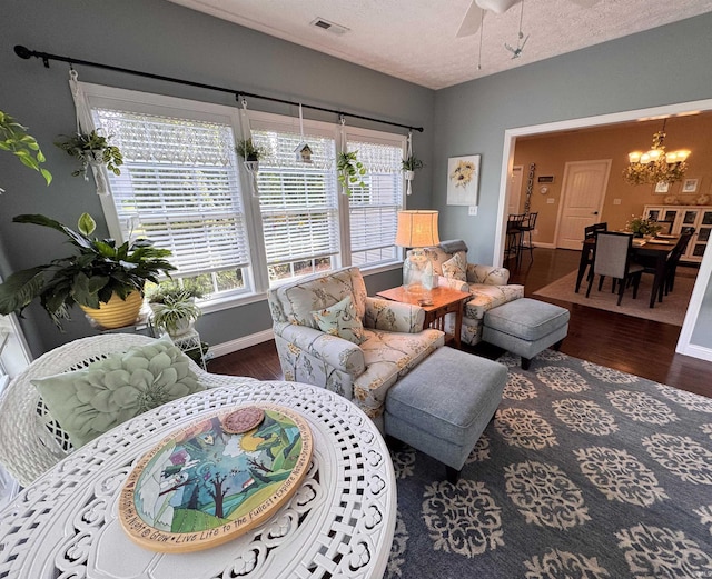 4691 Flagship Ln, Lafayette, IN 47909 - living room featuring a chandelier, wood finished floors, baseboards, ceiling fan, and a textured ceiling
