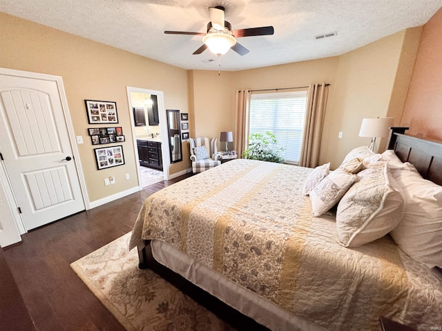 4691 Flagship Ln, Lafayette, IN 47909 - bedroom with dark wood-type flooring, a textured ceiling, ceiling fan, baseboards, and ensuite bath
