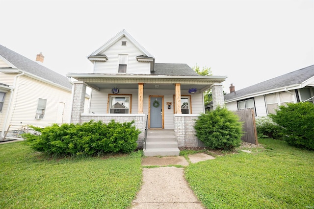1014 W 7th St, Mishawaka, IN 46544 - view of front of home with covered porch and a front lawn
